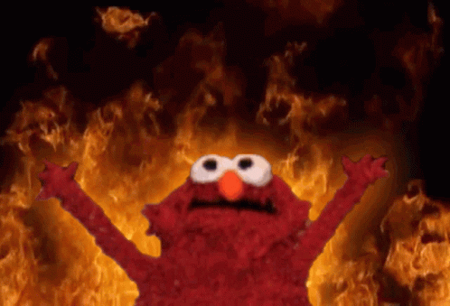 Elmo Standing in Front of Fire Wall