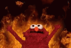 Elmo Standing in Front of Wall of Fire
