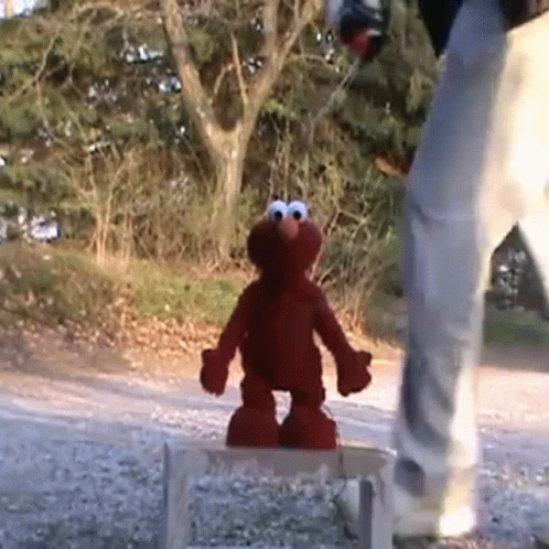 Elmo Standing on Wooden Stool