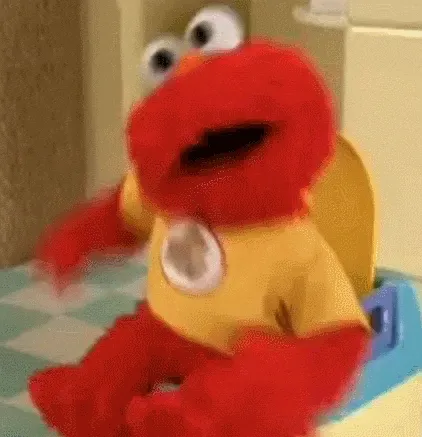 Elmo wackelt mit dem Kopf auf der Toilette