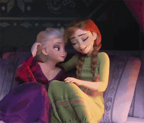 Elsa And Anna Are Sitting On A Couch And Hugging GIF