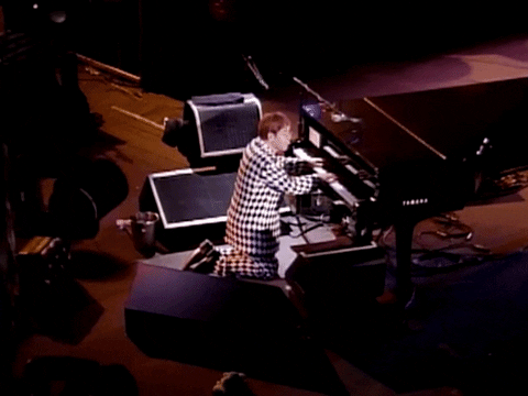 Elton John Kneeling While Playing Piano GIF