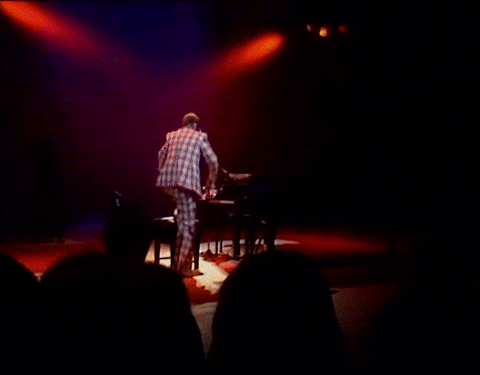 Elton John Standing On Top Of Piano GIF