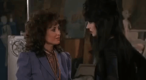 Elvira Going Past Anchorwoman GIF