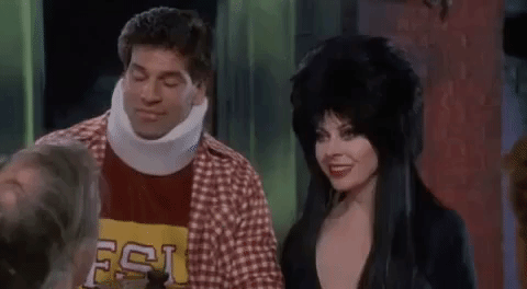 Elvira Kissing A Man On The Forehead GIF
