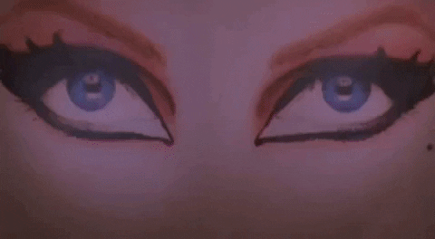 Elvira Making Her Way Through A Poster GIF