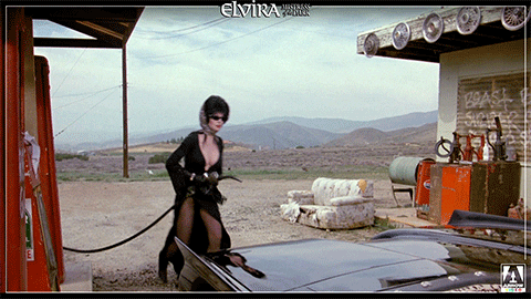 Elvira Trying To Fill Her Car Gas Tank GIF