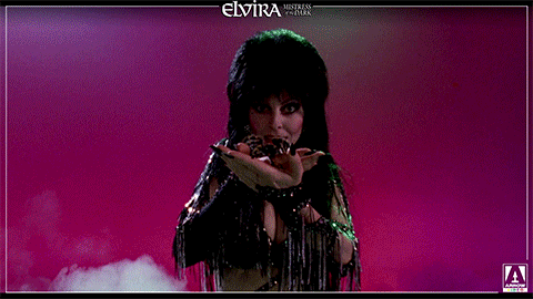 Elvira With A Spider On Her Palm GIF