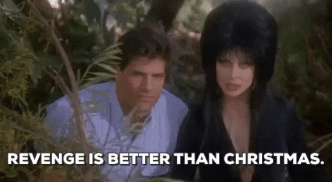 Elvira With Bob Redding In The Bushes GIF