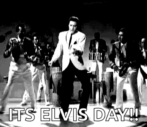 Elvis Presley Is Dancing On Stage In A Black And White Photo With A Band Behind Him . GIF