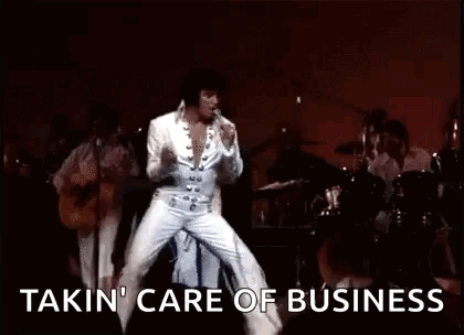 Elvis Presley Is Dancing On Stage While Playing A Guitar And Singing . GIF