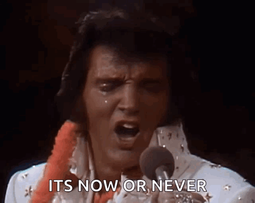 Elvis Presley Singing Into A Microphone With The Words " It 'S Now Or Never " Behind Him GIF