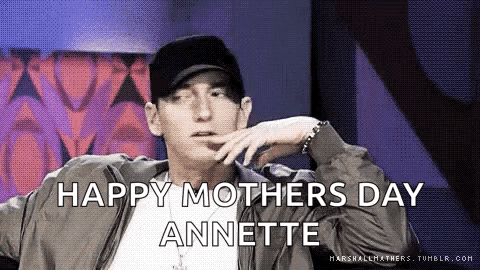 Eminem Is Wearing A Hat And A Jacket And Says `` Happy Mother 'S Day Annette '' While Sitting Down . GIF