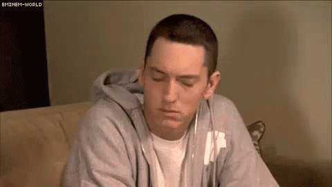 Eminem on Couch Wearing Headphones and Hoodie