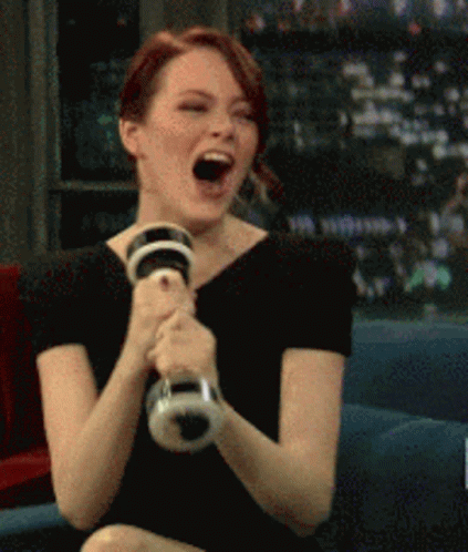 Giggly Emma Stone Shaking A Dumbbell GIF