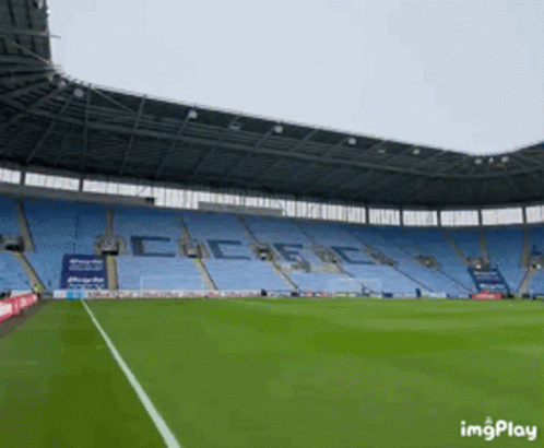 Empty Soccer Stadium With Coca-Cola On Stands GIF