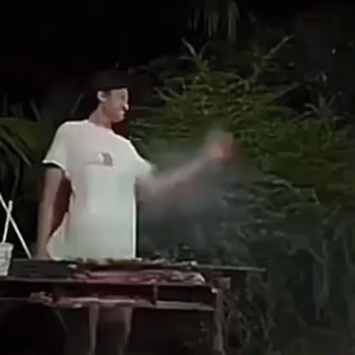 Enraged Man Tossing Fan In Grill GIF