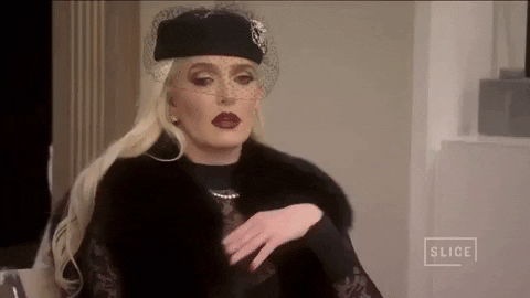 Erika Jayne Brushing Off Nonchalant Reaction GIF