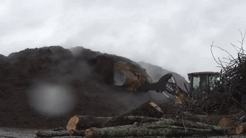 Excavator Making Mountains Of Mulch GIF