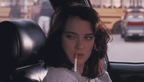Eye Rolling Winona Ryder Biting Cigarette GIF