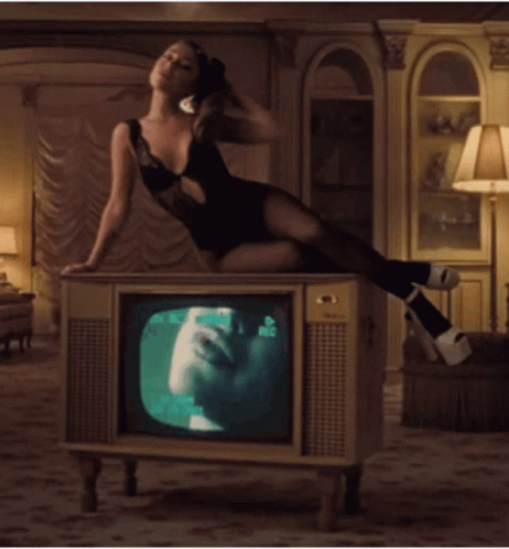 Fabulous Ariana Grande Sitting On Tv GIF