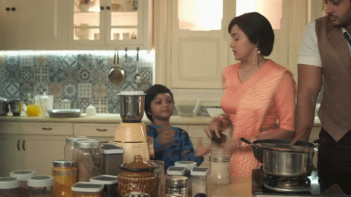 Family Preparing Food in Kitchen With Blender and Pots