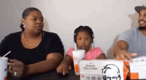 Family Sitting at Table with KFC