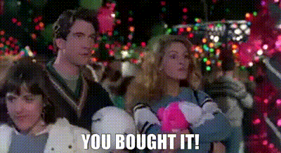 Family Sitting by Christmas Tree Saying You Bought It