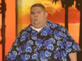Fat Man in Blue Floral Shirt Standing in Front of Palm Tree