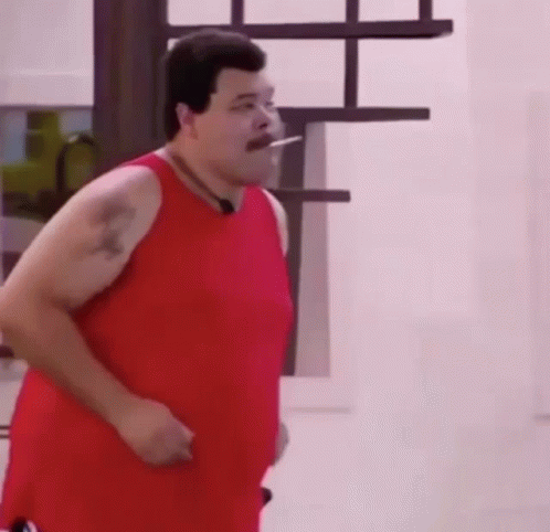 Fat Man in Red Tank Top Smoking Cigarette While Running