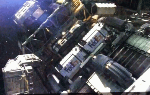 Fedex Boxes Are Stacked On Top Of Each Other In A Dark Room GIF