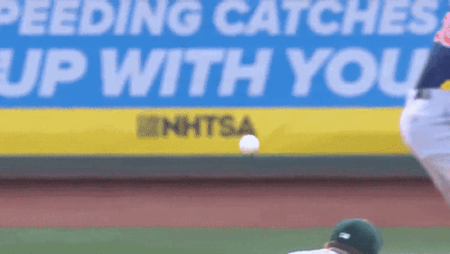 Feeding Catches Up With You Sign Behind Baseball Player