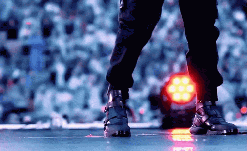 Feet Standing In Front Of Red Light GIF