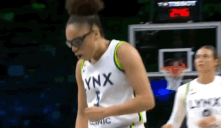 Female Basketball Player In Lynx Jersey Beside Hoop GIF