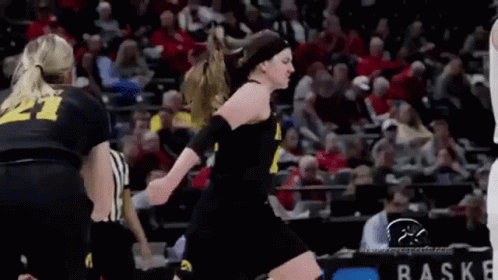 Female Basketball Player Jumping With Referee