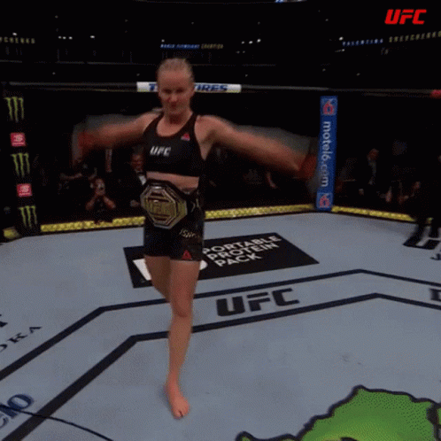 Female Fighter in UFC Ring With Toyo Tires Banner