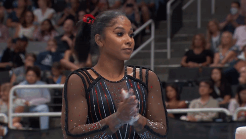 Female Gymnast Clapping Before Crowd