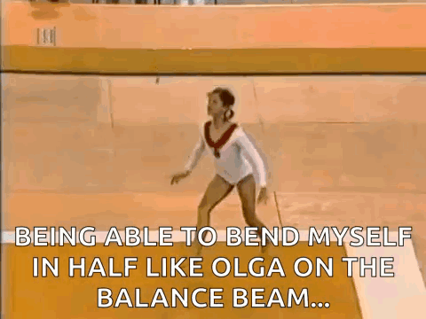 Female Gymnast Doing Balance Beam Trick
