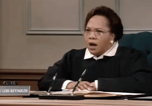 Female Judge Lois Reynolds At Desk GIF