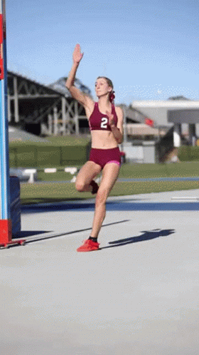 Female Runner in Maroon Top With Number 2