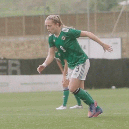 Female Soccer Player in Green Jersey Number 9