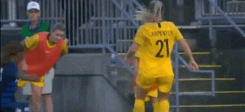 Female Soccer Players Around Referee