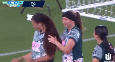 Female Soccer Players Hugging on Field