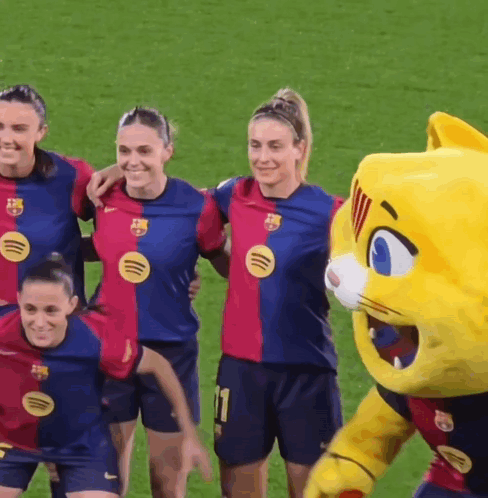 Female Soccer Players Posing With Mascot