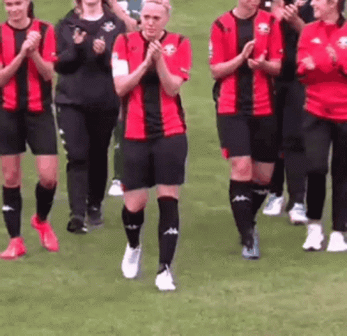 Female Soccer Players Walking on Field