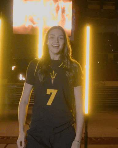 Female Softball Player in Maroon and Gold Duke Uniform