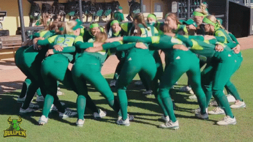 Female Softball Players Huddle With Bullpen Logo