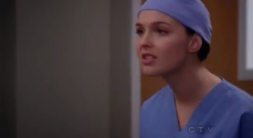 Female Surgeon in Purple Hat and Scrubs