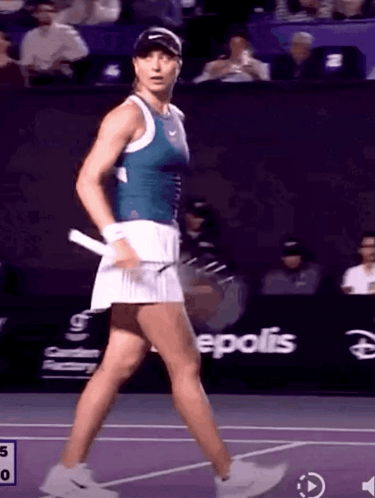 Female Tennis Player Walking on Court With Epolis