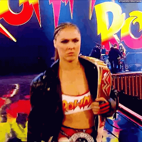 Female Wrestler Holding Championship Belt